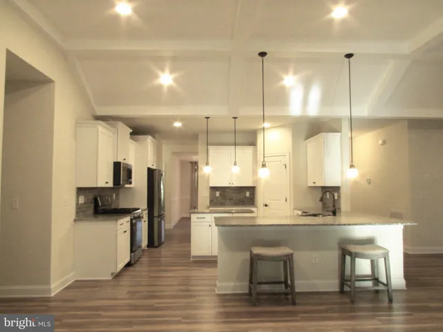 a large kitchen with a table and chairs