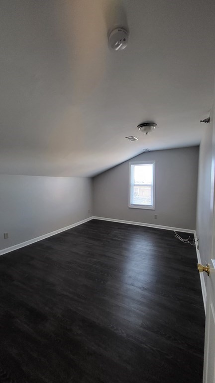 124 Stevens Street, Unit 5 Lowell, MA 01851 - Photo 15 of 15 an empty room with wooden floor and windows