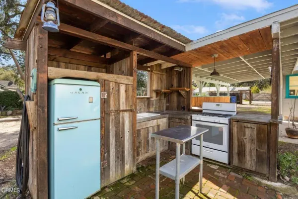 a kitchen with a refrigerator and white cabinets