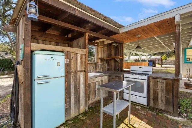 a kitchen with a refrigerator and white cabinets