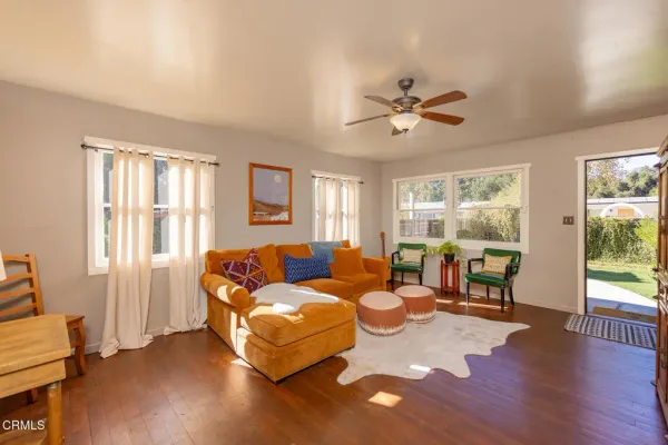 a living room with furniture and wooden floor