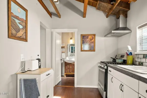 a kitchen with stainless steel appliances a stove a sink and a refrigerator