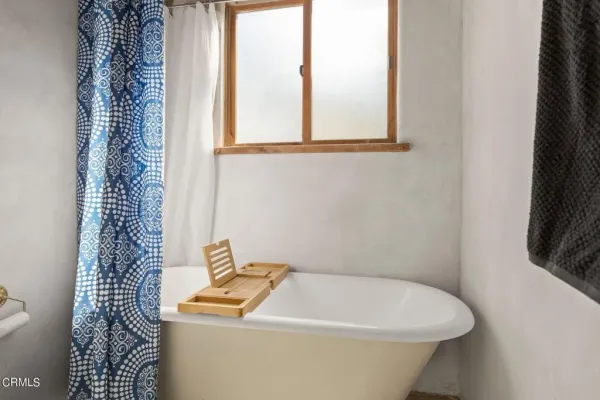 a backyard of a house with table and chairs