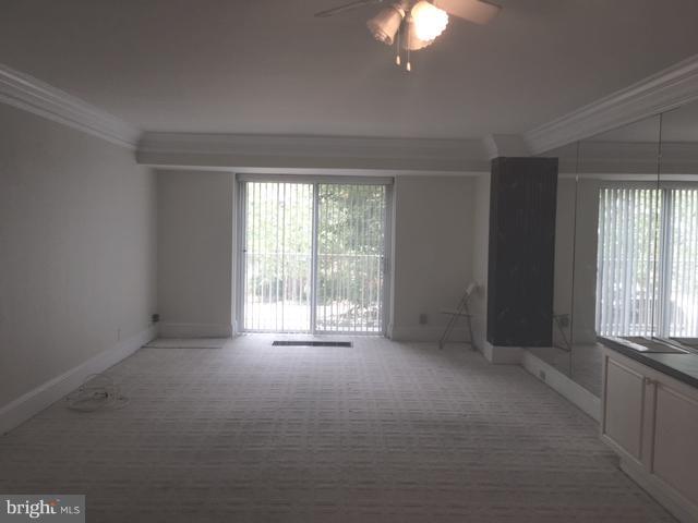 560 N Street Southwest, Unit N107 Washington, DC 20024 - Photo 3 of 10 an empty room with windows