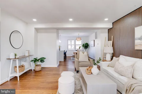 a kitchen with stainless steel appliances a sink a stove a refrigerator a sink a counter space and cabinets