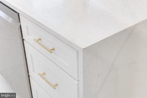 a bedroom with a bed chandelier and a window