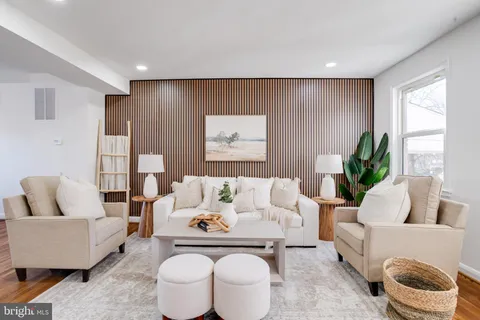 a living room with furniture flowerpot and a window