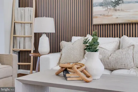 a dining room with furniture a chandelier and wooden floor
