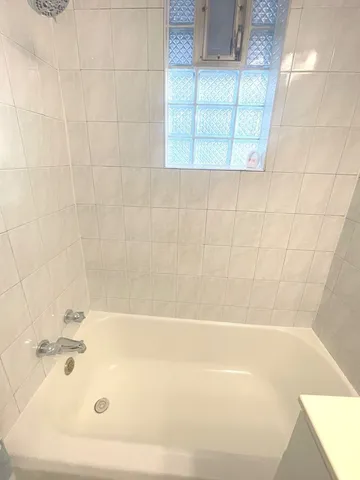 a white bath tub sitting in a bathroom