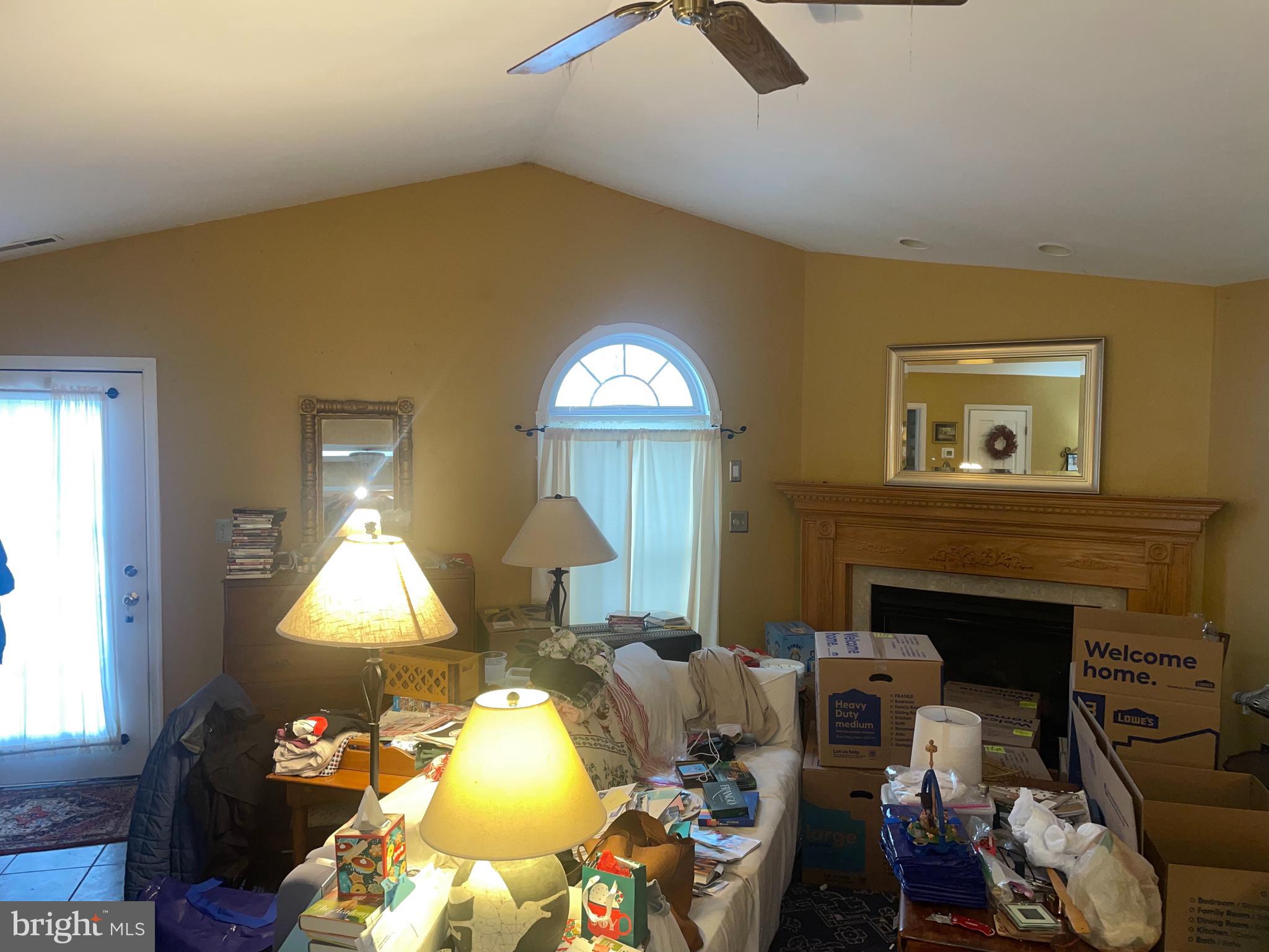 1807 Sutton Avenue Baltimore, MD 21227 - Photo 23 of 26 a living room with furniture and a fireplace