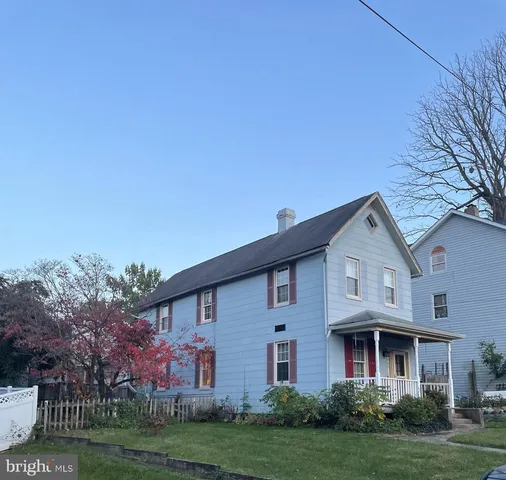a view of a yard in front of a brick house