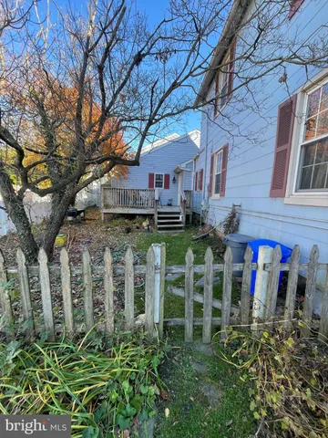 a view of a chairs and table in front of a house
