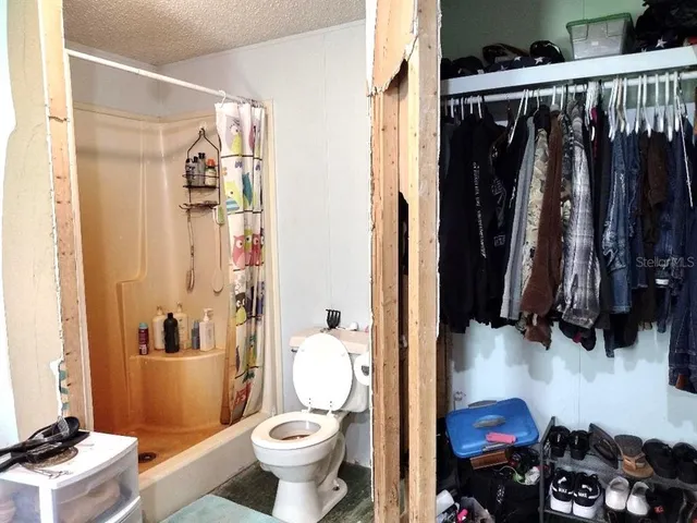a bathroom with a toilet and a shower