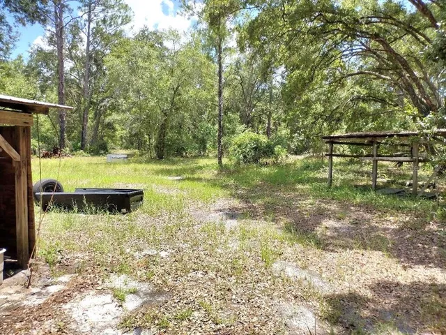 a backyard of a house with yard and outdoor seating
