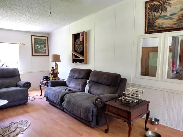 a living room with furniture a rug and a window