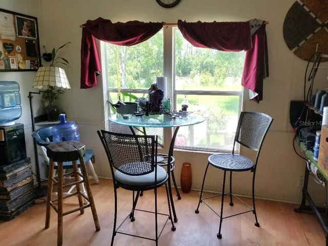 a view of a dining room with furniture window and outside view
