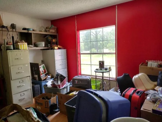 a room with furniture a flat screen tv and a window