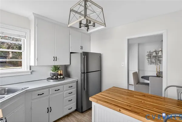 a kitchen with cabinets appliances and a window