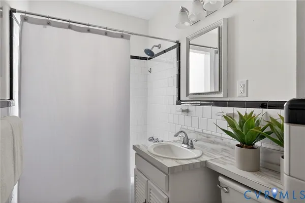 a bedroom with a bed mirror and window