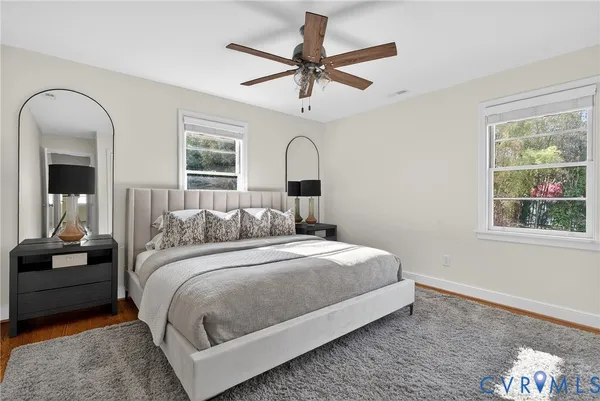a bedroom with a large bed chandelier and a window