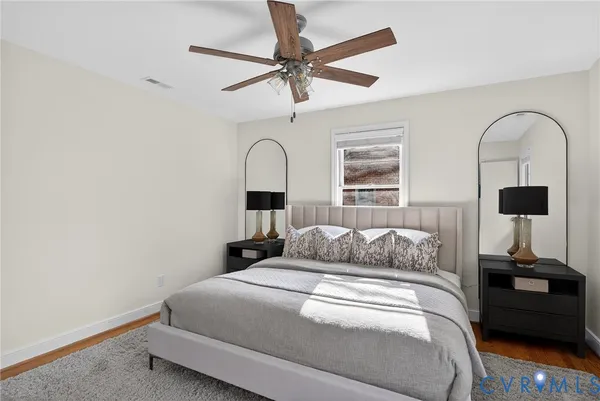 a bedroom with a bed and view of bathroom