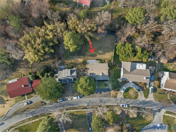 an aerial view of residential house with outdoor space and trees