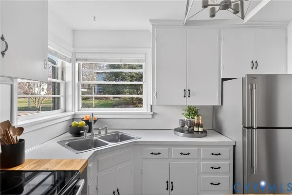 a kitchen with appliances cabinets and a window