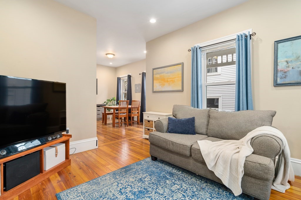 9 Baker Road Everett, MA 02149 - Photo 4 of 14 a living room with furniture and a flat screen tv