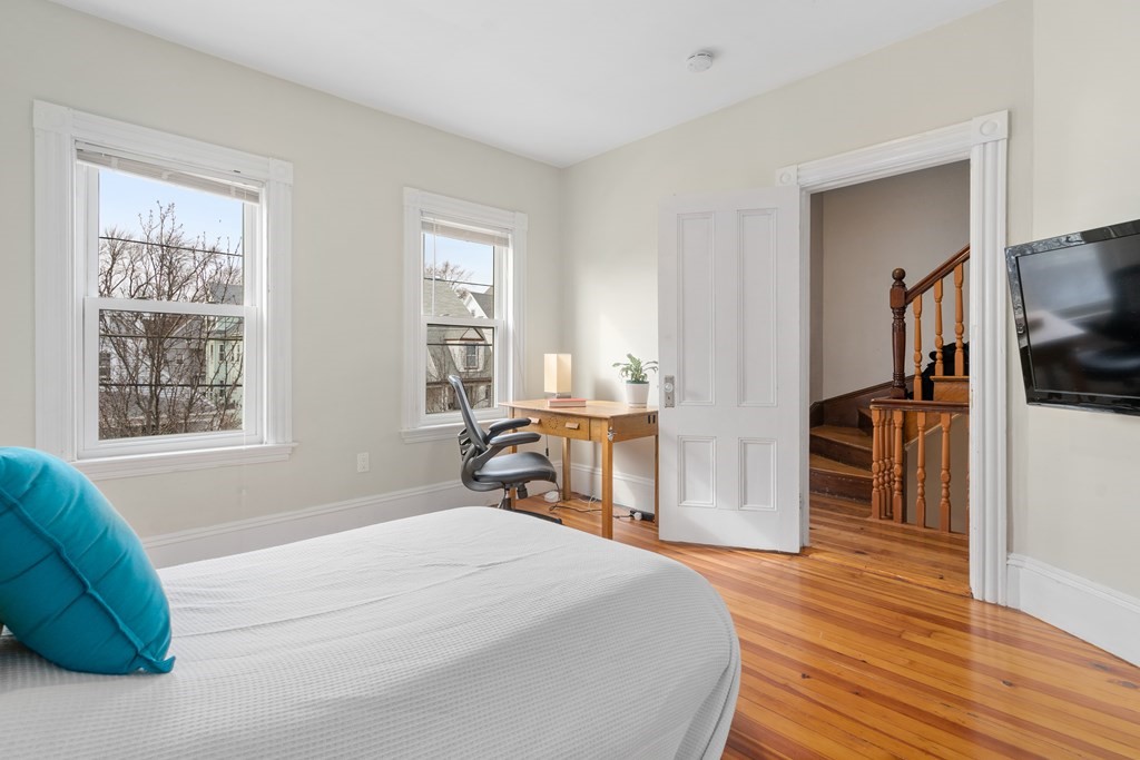 9 Baker Road Everett, MA 02149 - Photo 9 of 14 a bedroom with a bed and wooden floor