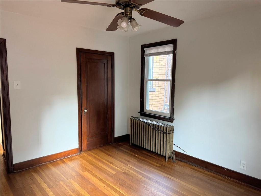 538 Halsey Avenue, Unit 2 Pittsburgh, PA 15221 - Photo 2 of 6 an empty room with a window and wooden floor
