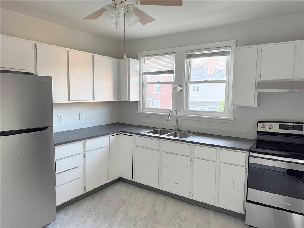 538 Halsey Avenue, Unit 2 Pittsburgh, PA 15221 - Photo 4 of 6 a kitchen with granite countertop white cabinets and white appliances