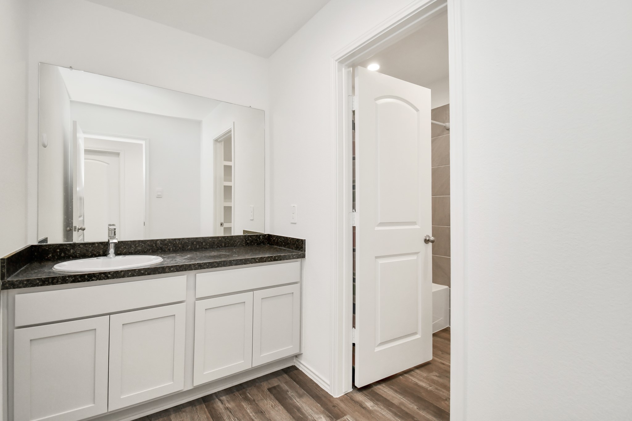 5315 Castlebury Meadows Dr Spring Spring, TX 77373 - Photo 23 of 39 a bathroom with a granite countertop sink and a mirror