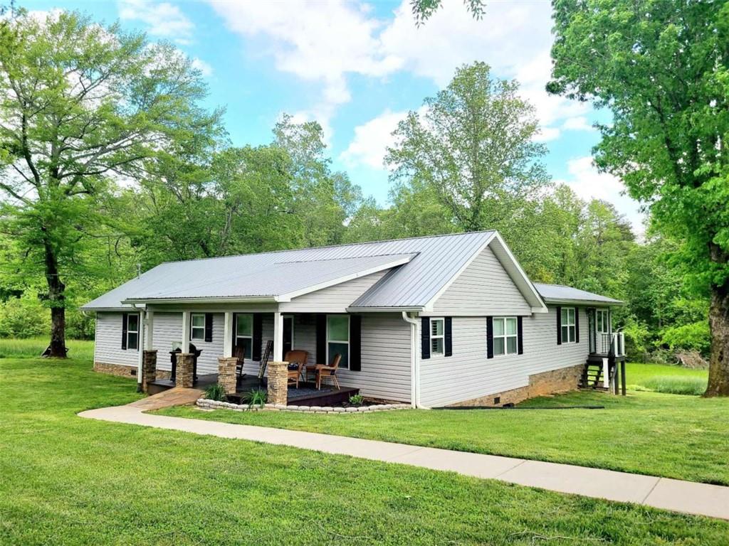 a front view of a house with a garden and porch