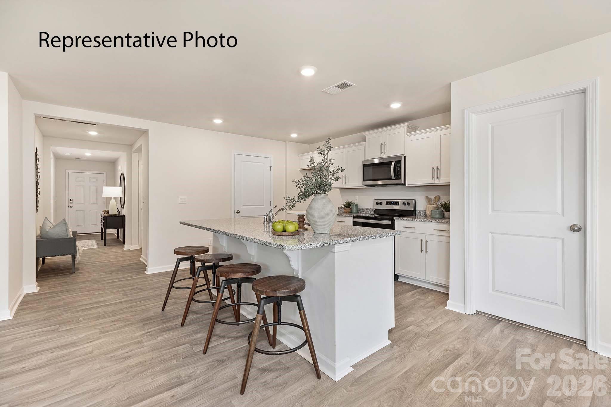2696 Goose Fair Road Maiden, NC 28650 - Photo 14 of 21 a kitchen with white cabinets and stainless steel appliances