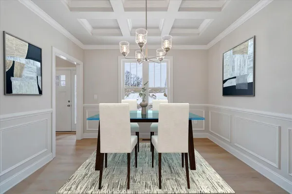 a view of a dining room with furniture and chandelier
