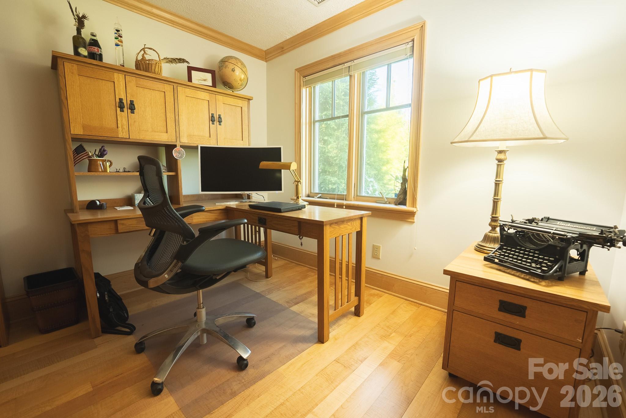 6985 Junaluska Road Boone, NC 28607 - Photo 16 of 35 a view of a workspace with furniture and a window