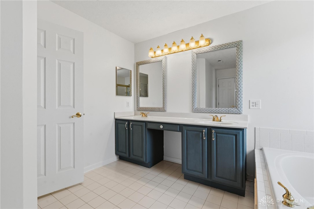 70 Martin Lane Springboro, OH 45066 - Photo 39 of 69 This spacious bathroom features dual vanities and a relaxing soaking tub for ultimate comfort.