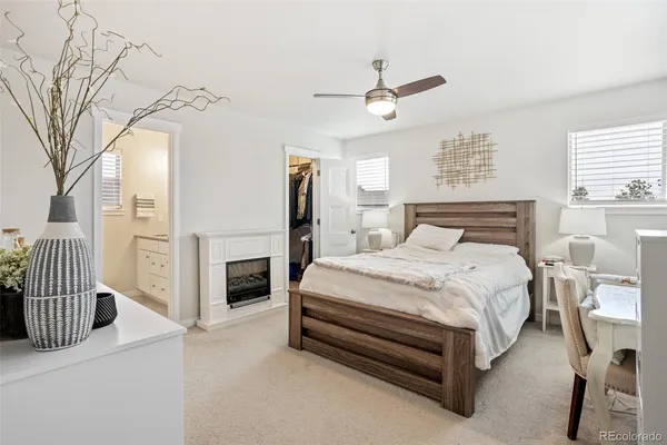 a bedroom with a bed fireplace and a window
