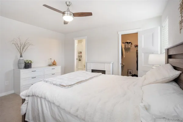 a bedroom with a large bed and dresser