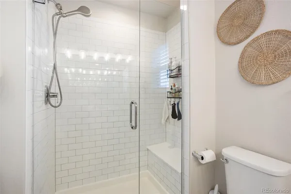 a bathroom with a granite countertop shower sink and toilet