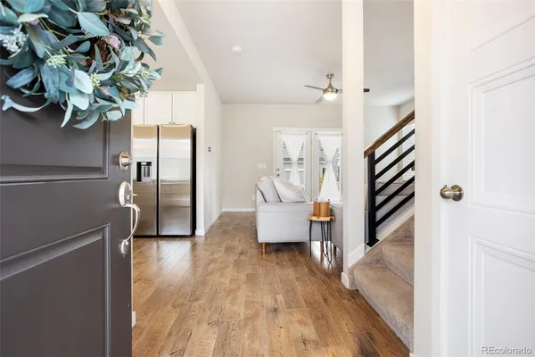 a living room with furniture and a wooden floor