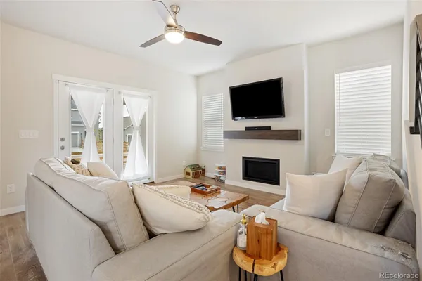 a living room with furniture a flat screen tv and a fireplace