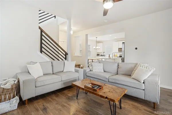 a living room with furniture and a wooden floor