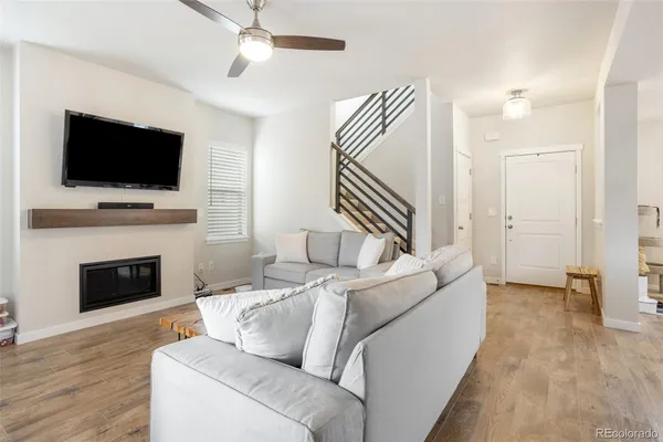 a living room with furniture a flat screen tv and a fireplace