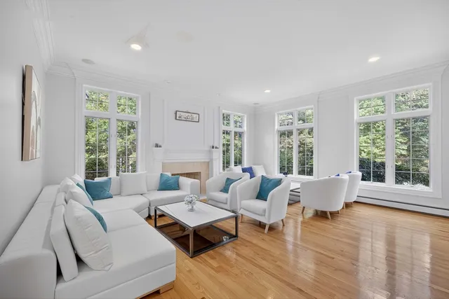 a living room with furniture and floor to ceiling windows