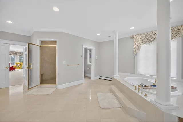 a spacious bedroom with a bed and a couch