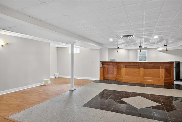 a kitchen with stainless steel appliances white cabinets and a window