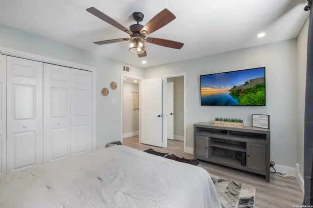 a bedroom with a bed and a flat screen tv