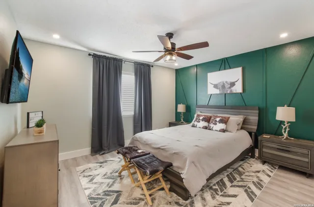 a bedroom with a bed and a flat screen tv