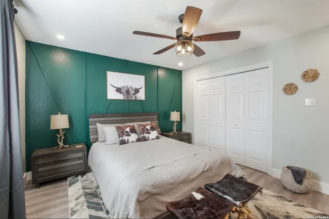 a bedroom with a bed and a chandelier